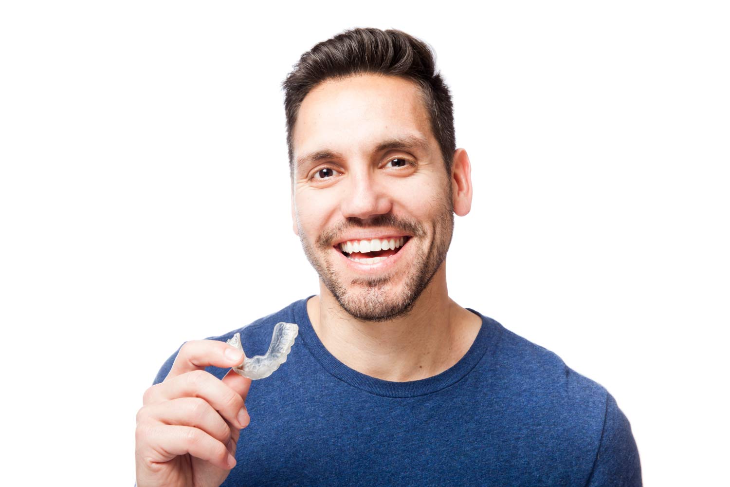 A smiling man holds a clear aligner.
