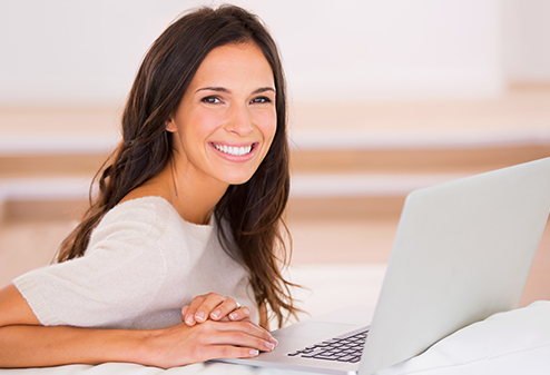 smiling woman with open laptop