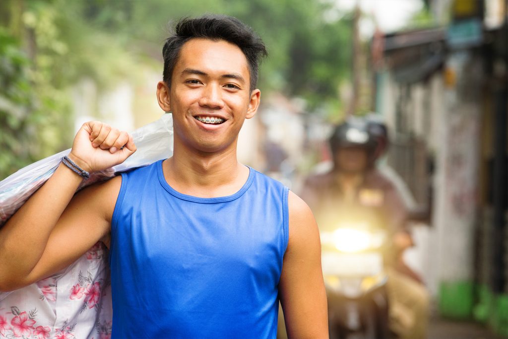 orthodontic treatments, smiling man with braces